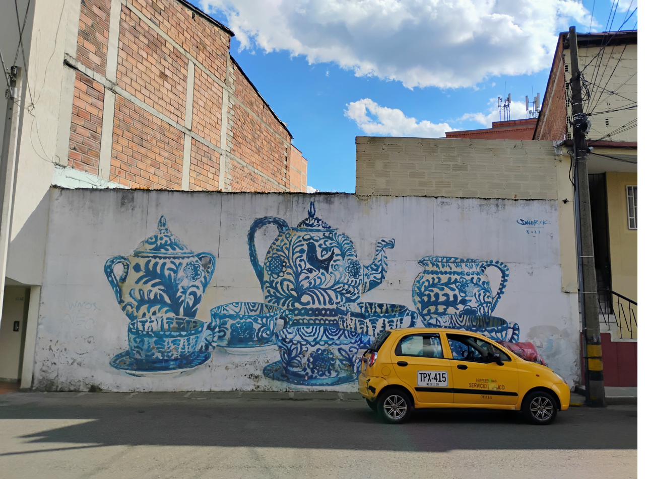 Blue talavera pottery mural with yellow taxi